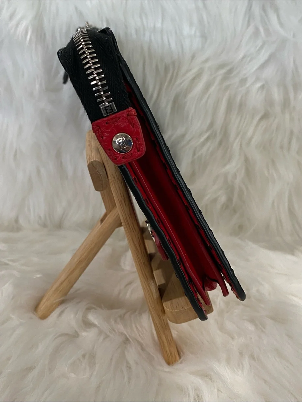 Fendi Selleria flat clutch bag with red stitching and red leather handle